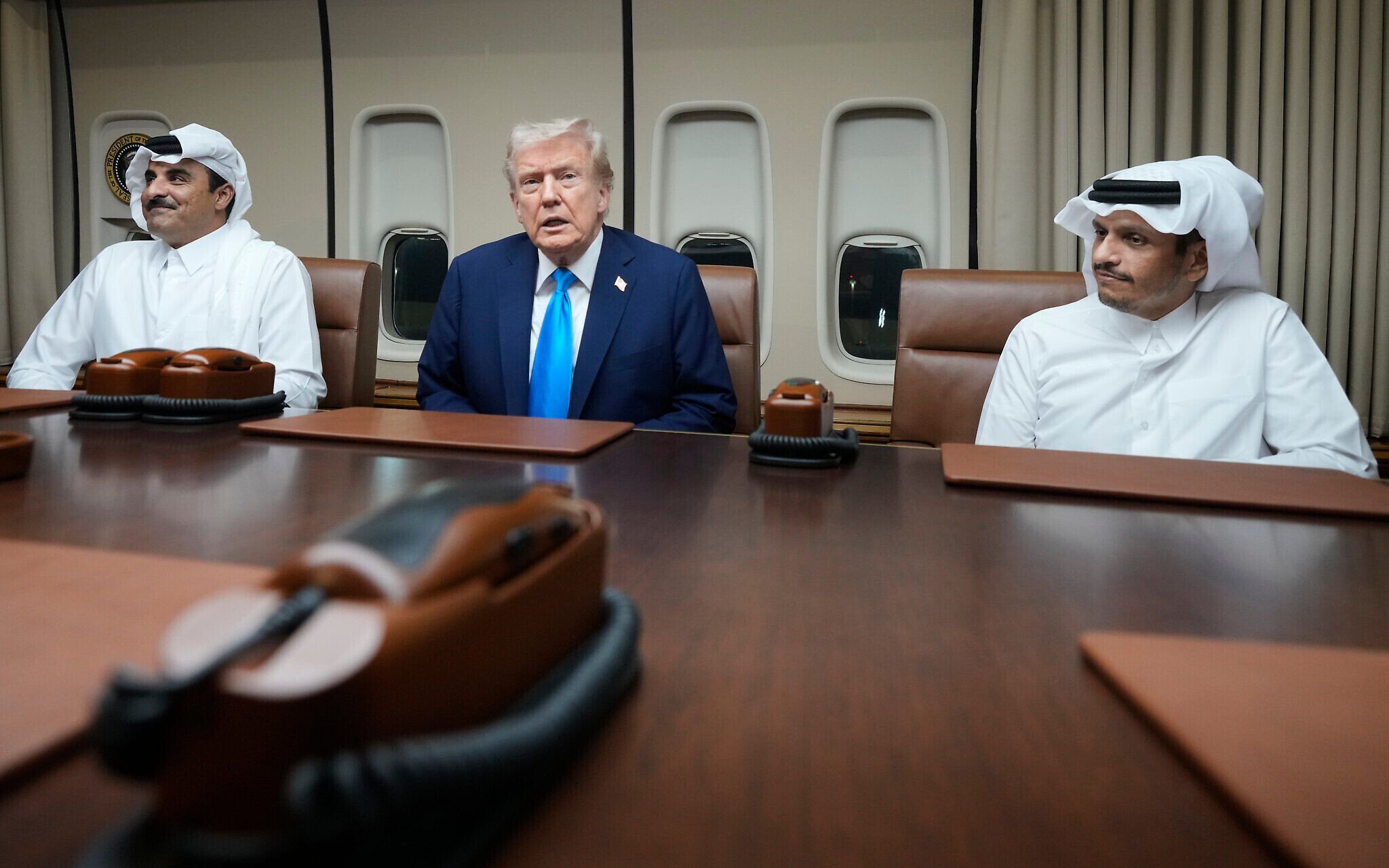 President Donald Trump, center, meets with Emir of Qatar Sheikh Tamim bin Hamad al-Thani, left, and Qatari Prime Minister and Foreign Minister Sheikh Mohammed bin Abdulrahman bin Jassim Al Thani aboard Air Force One at Al Udeid Air Base in Doha, Qatar, October 25, 2025. (AP/Mark Schiefelbein)